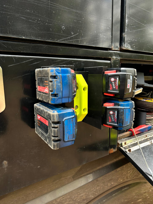 Cold Composites M18 Battery Holder Attachment with 4 Milwaukee M18 batteries mounted magnetically to a steel surface.