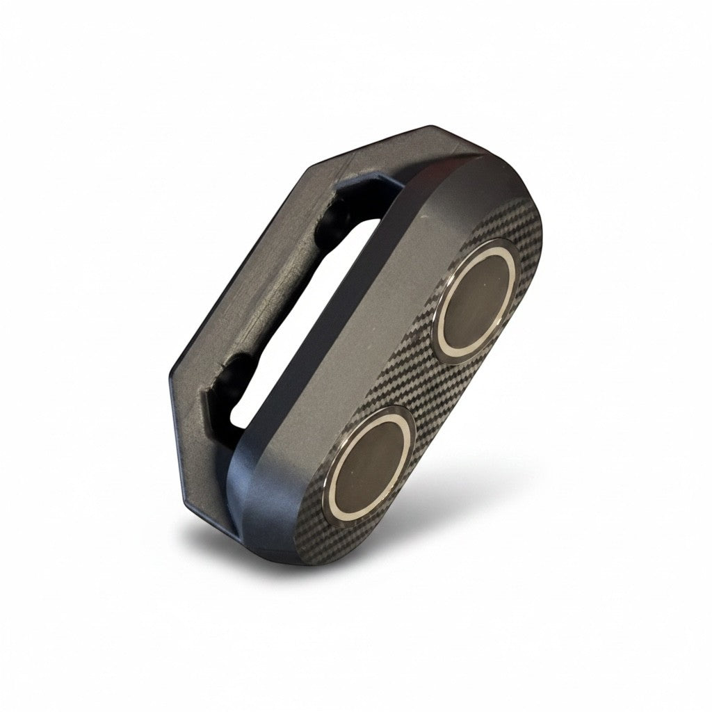 Cold Composites MagLug battery holder kit with magnetic handle and M18 battery holder attachment, featuring carbon fiber accents.