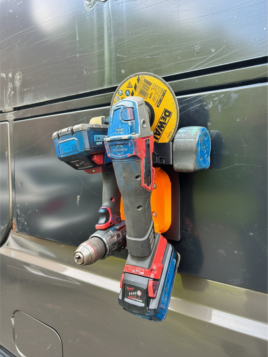 Cold Composites MagLug Workstation Lite in orange holding a cordless drill and angle grinder on a metal surface.